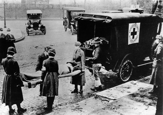 American Red Cross volunteers carry a Spanish flu victim, 1919. (Image via British Red Cross - flickr)