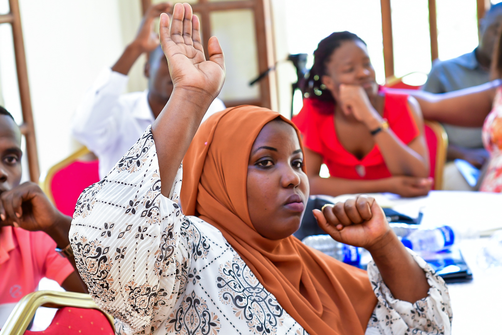 A young Democracy School participant raises her hand